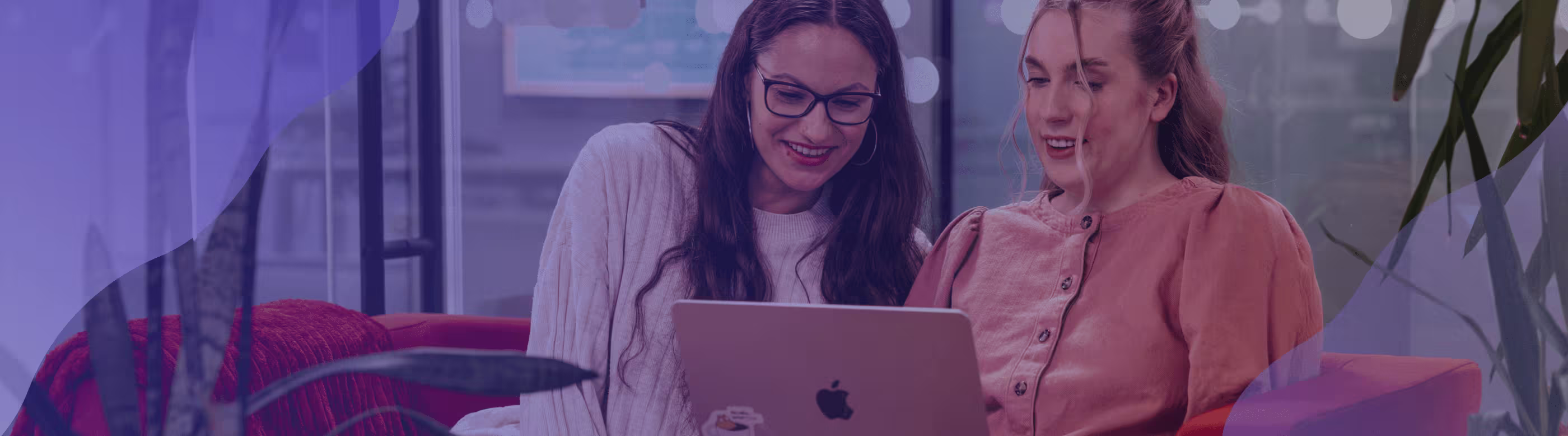 Two women looking at a laptop