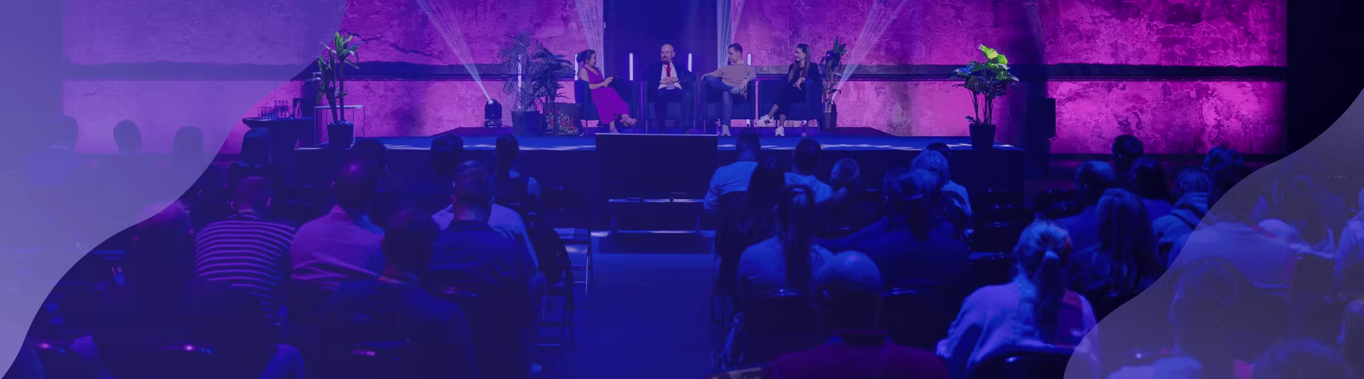People sitting and talking on a stage