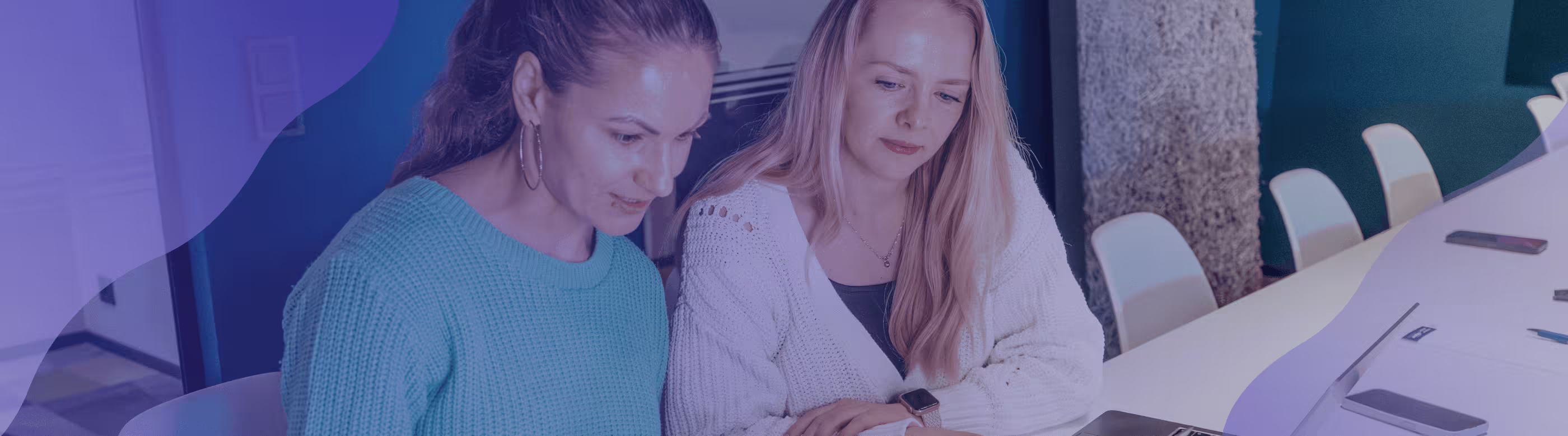 Two women looking at a laptop